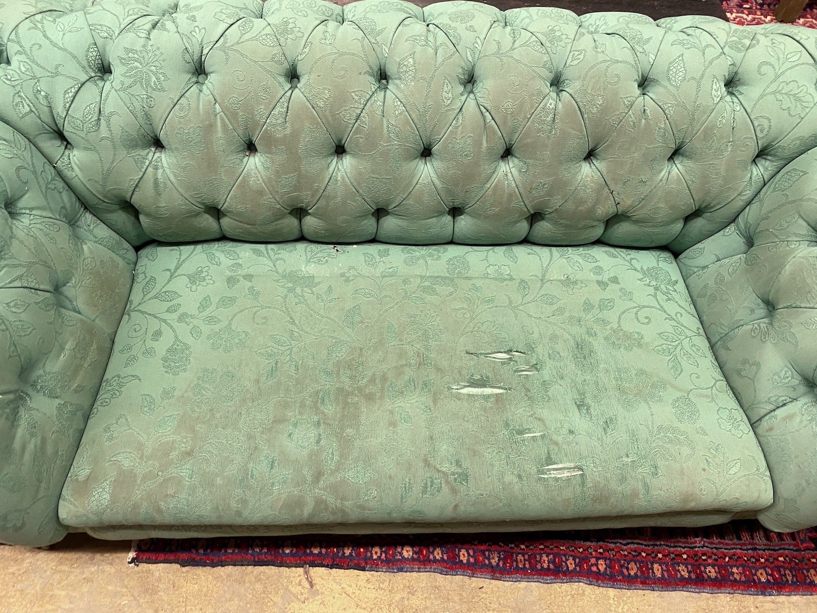 A Victorian double drop arm Chesterfield settee upholstered in a deep buttoned green fabric, length 190cm, width 88cm, height 70cm